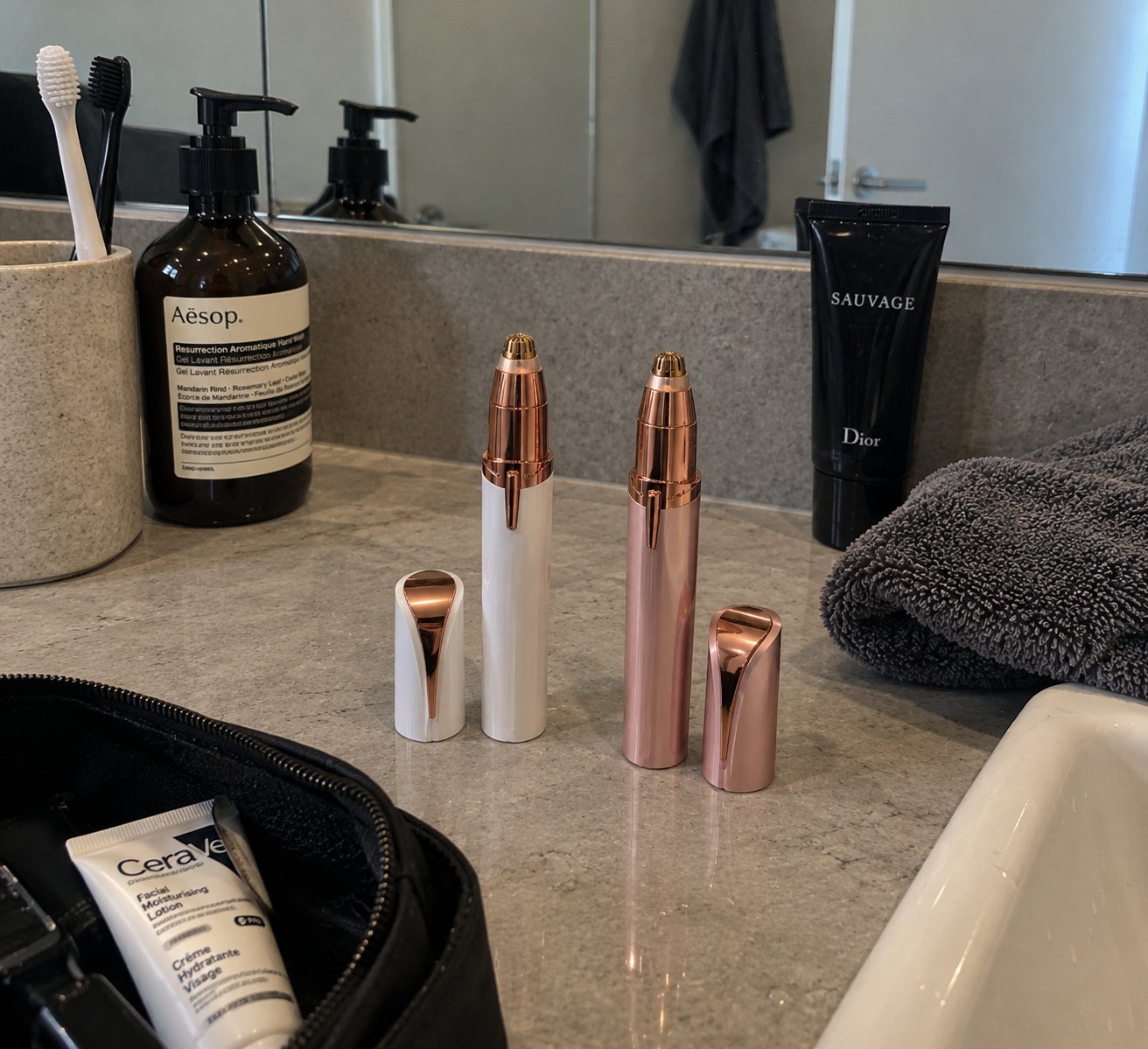 Both Wingman colourways — White + Gold and Rose + Rose Gold — on a marble bathroom counter